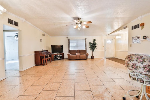 tiled living room with crown molding and a textured ceiling