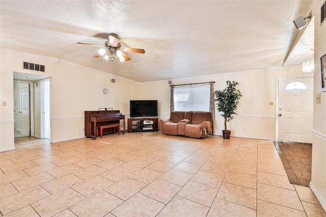 living room with light tile patterned floors, a textured ceiling, and ceiling fan