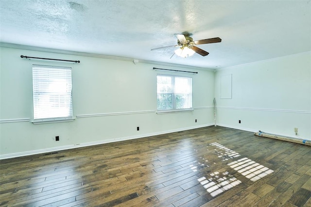 empty room featuring a textured ceiling, dark hardwood / wood-style floors, ceiling fan, and ornamental molding