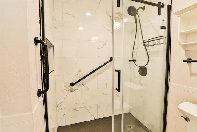 bathroom with toilet and a shower with shower door