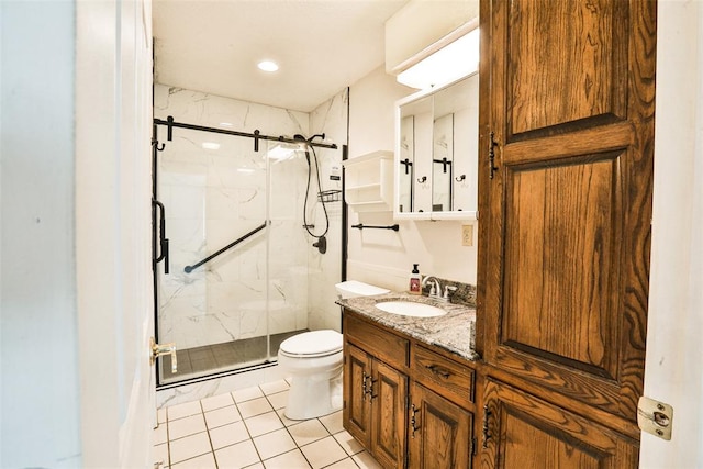 bathroom featuring tile patterned floors, a shower with door, vanity, and toilet