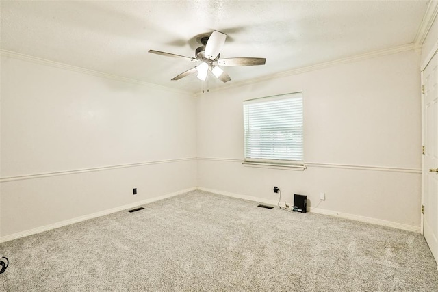 carpeted spare room featuring ceiling fan and ornamental molding