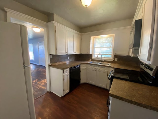 kitchen featuring dishwasher, range, white refrigerator, and white cabinetry