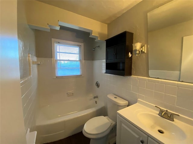 full bathroom with vanity, toilet, tile walls, and tiled shower / bath