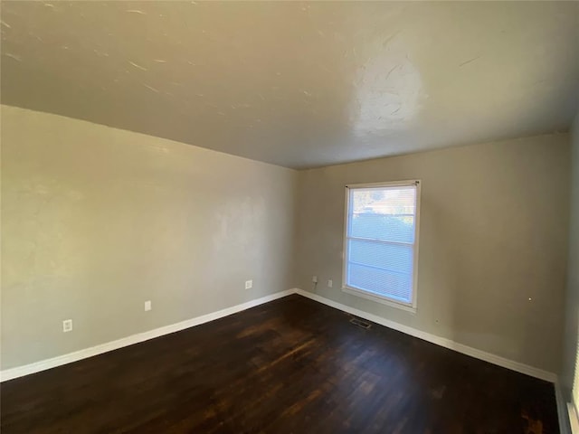 spare room with hardwood / wood-style floors