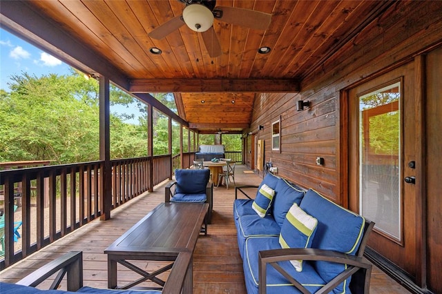 deck with outdoor lounge area and ceiling fan