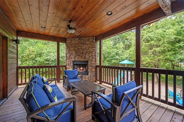 wooden terrace featuring an outdoor living space with a fireplace and ceiling fan