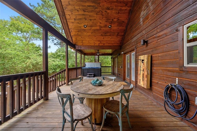 wooden terrace with ceiling fan and a jacuzzi