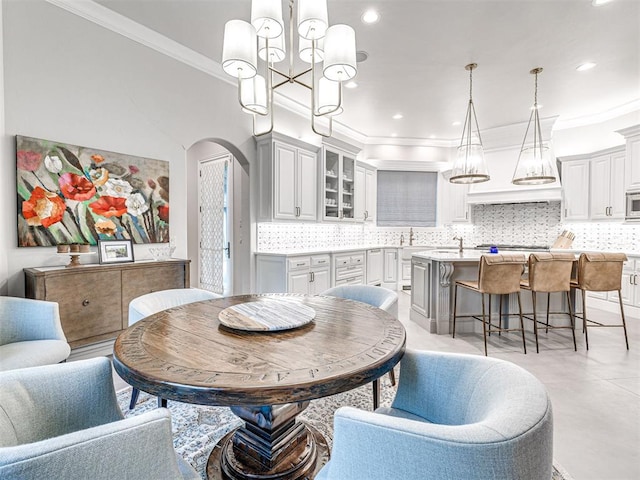 dining room with ornamental molding and sink