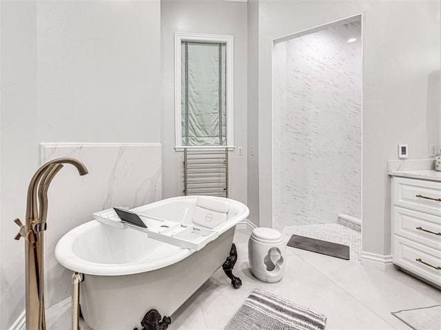 bathroom featuring tile patterned floors, a washtub, and vanity