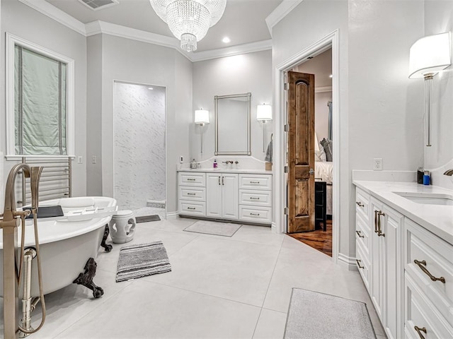 bathroom featuring tile patterned floors, ornamental molding, a tub, and an inviting chandelier