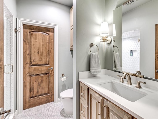 bathroom featuring tile patterned flooring, vanity, and toilet