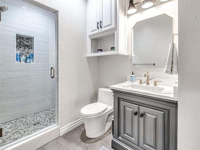 bathroom featuring toilet, vanity, tile patterned floors, and walk in shower