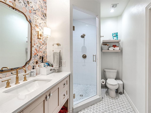 bathroom with tile patterned floors, vanity, toilet, and a shower with shower door