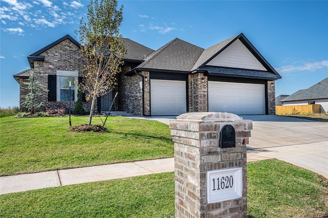 single story home featuring a garage and a front lawn