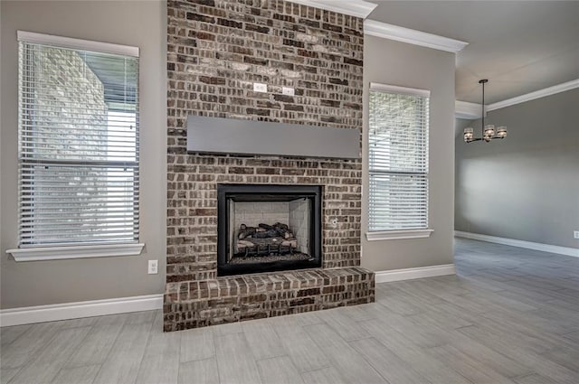 interior details with crown molding, hardwood / wood-style floors, an inviting chandelier, and a brick fireplace