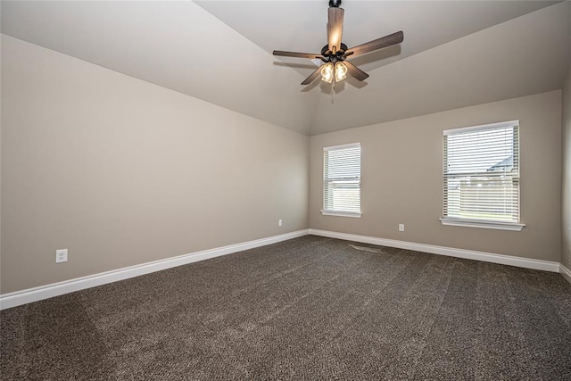 empty room with ceiling fan, carpet floors, and vaulted ceiling