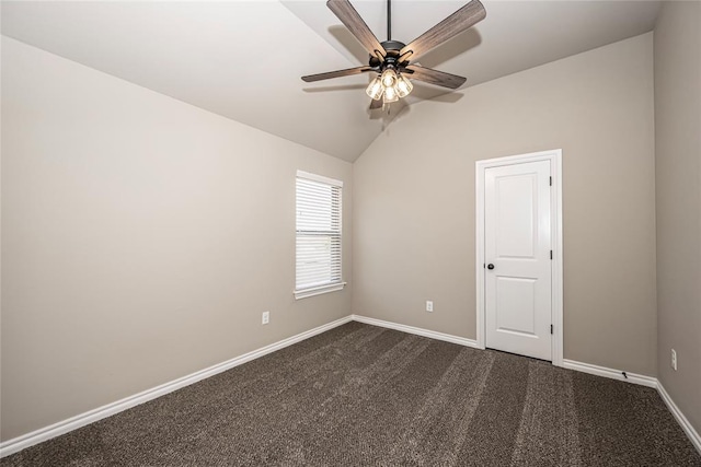 carpeted spare room featuring vaulted ceiling and ceiling fan