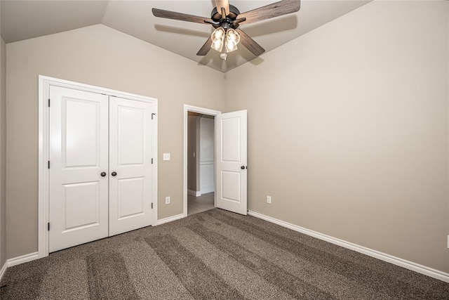 unfurnished bedroom featuring carpet flooring, ceiling fan, a closet, and vaulted ceiling