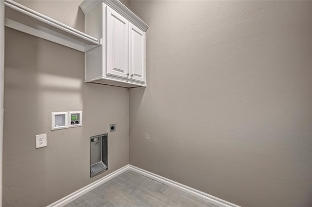 washroom featuring electric dryer hookup, cabinets, and hookup for a washing machine