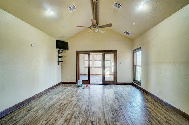 unfurnished room featuring wood-type flooring, high vaulted ceiling, and ceiling fan