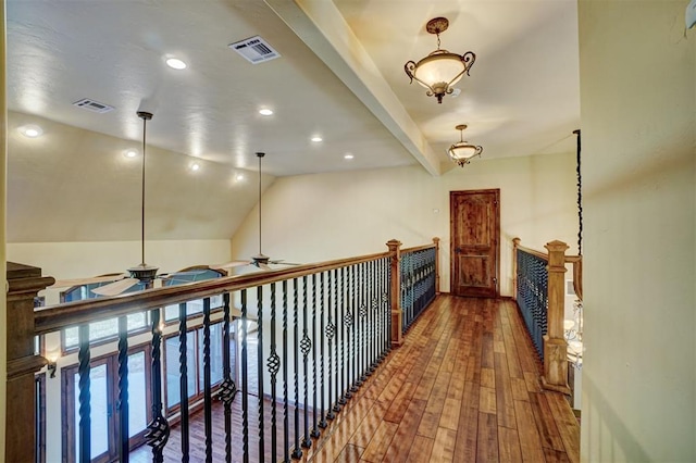 hallway featuring wood-type flooring and lofted ceiling