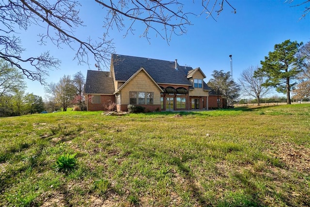 rear view of house with a yard