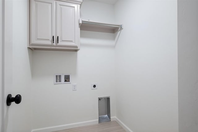 laundry room with cabinets, hookup for a washing machine, and electric dryer hookup