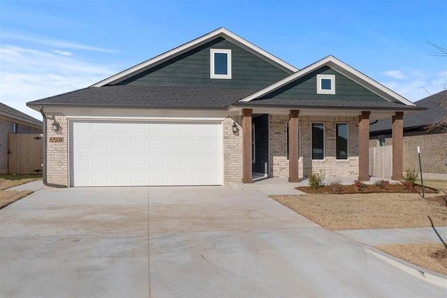 view of front of property featuring covered porch and a garage