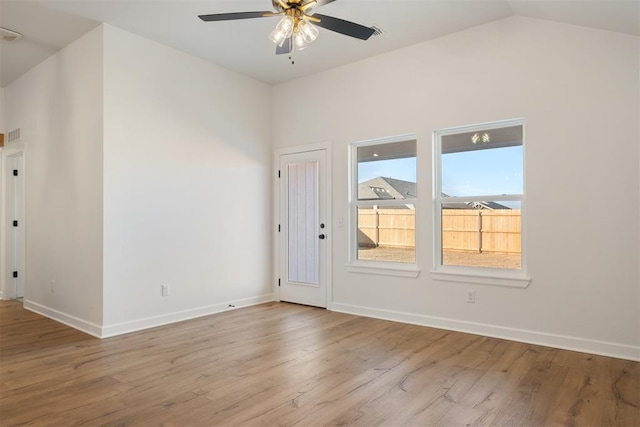 unfurnished room with light hardwood / wood-style floors, vaulted ceiling, and ceiling fan