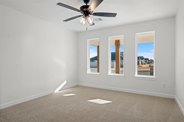 carpeted spare room featuring ceiling fan