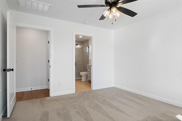 unfurnished bedroom with connected bathroom, ceiling fan, and light colored carpet