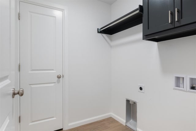 laundry room with hookup for an electric dryer, cabinets, hardwood / wood-style flooring, and washer hookup