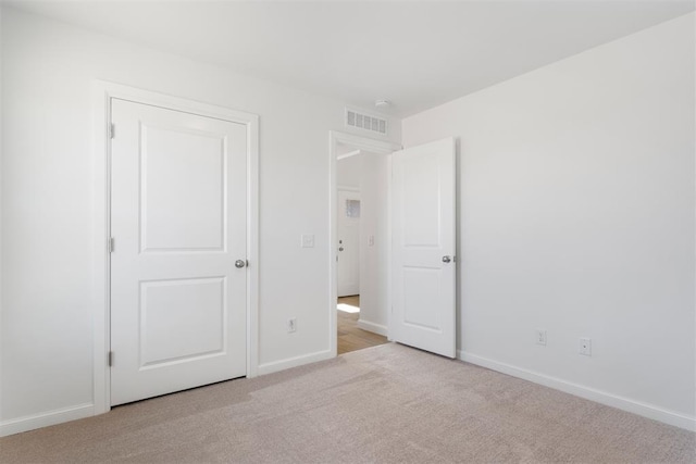 unfurnished bedroom featuring light colored carpet