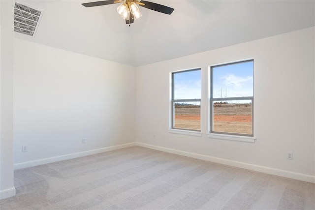 spare room featuring light colored carpet and ceiling fan