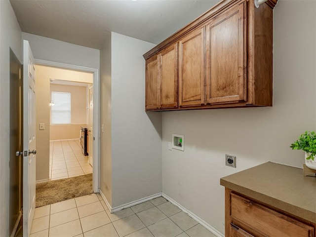 laundry room with cabinets, washer hookup, light tile patterned floors, and electric dryer hookup