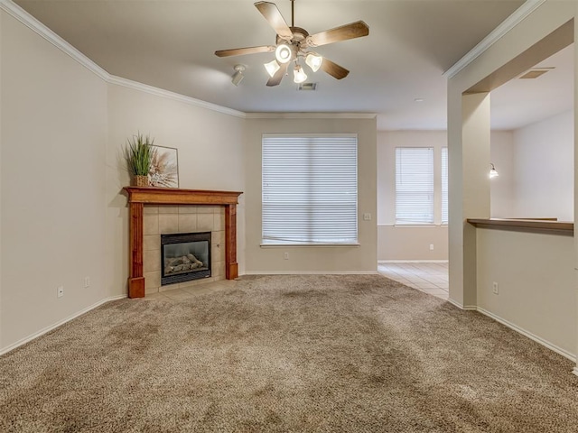 unfurnished living room with a fireplace, light colored carpet, ceiling fan, and ornamental molding