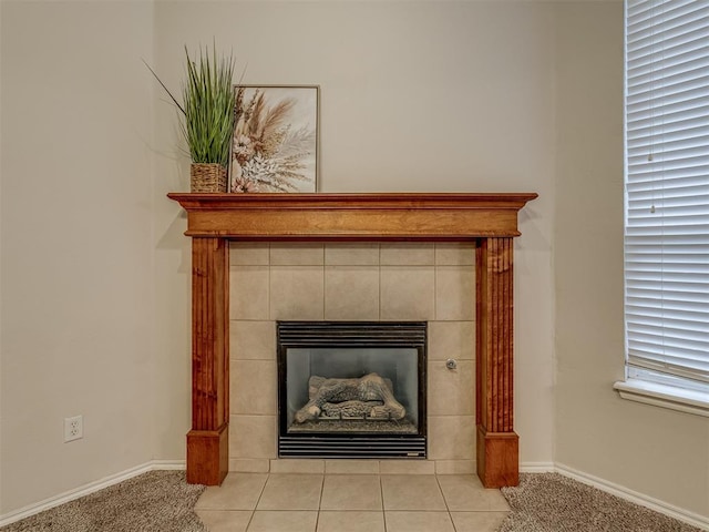 room details featuring a tile fireplace and carpet