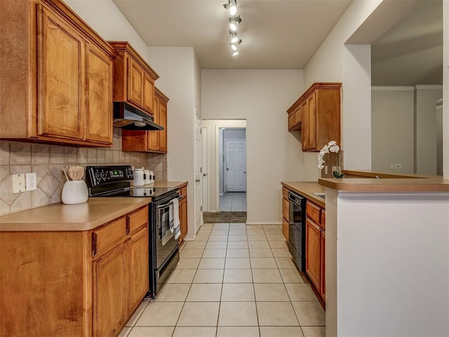 kitchen with light tile patterned floors, backsplash, and black appliances