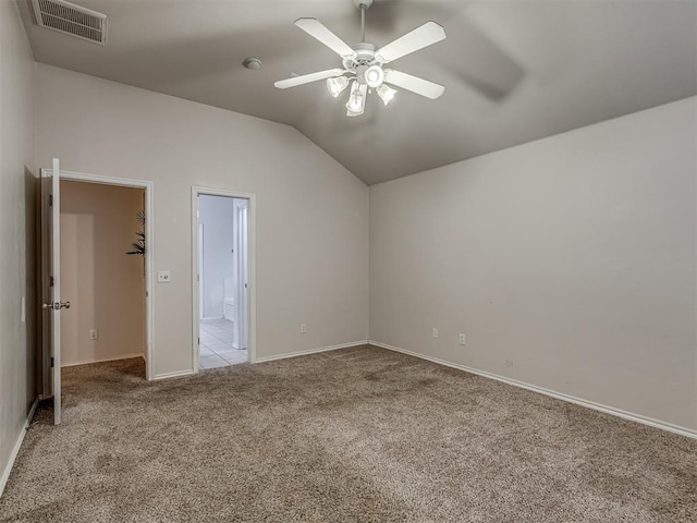 unfurnished bedroom with ceiling fan, lofted ceiling, and light carpet