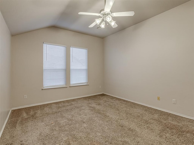 carpeted spare room featuring ceiling fan and lofted ceiling