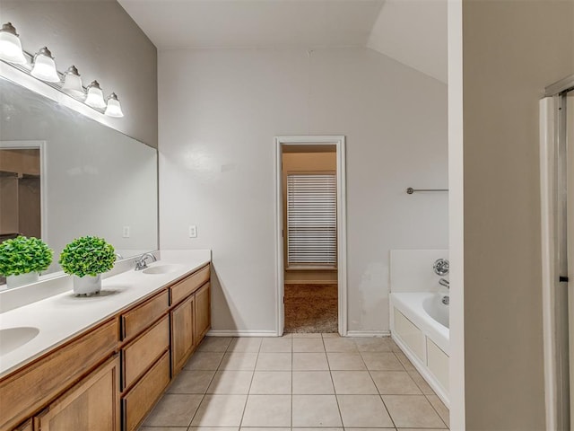 bathroom featuring tile patterned floors, vanity, a bathtub, and vaulted ceiling