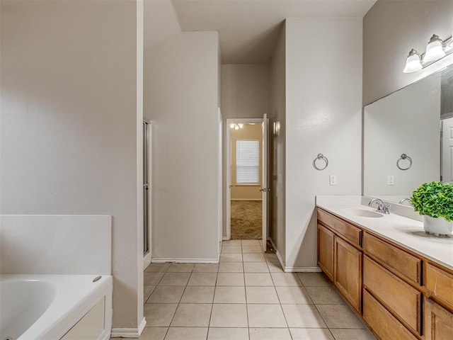 bathroom featuring tile patterned floors, vanity, and a bath