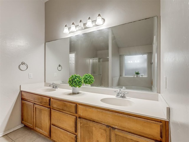 bathroom with tile patterned floors, vanity, and shower with separate bathtub