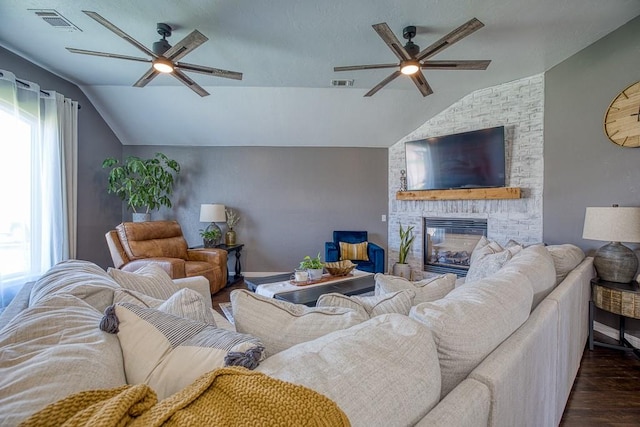 living room with dark hardwood / wood-style flooring, a fireplace, and vaulted ceiling