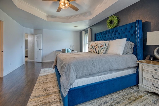 bedroom with ceiling fan, dark hardwood / wood-style floors, a raised ceiling, and crown molding