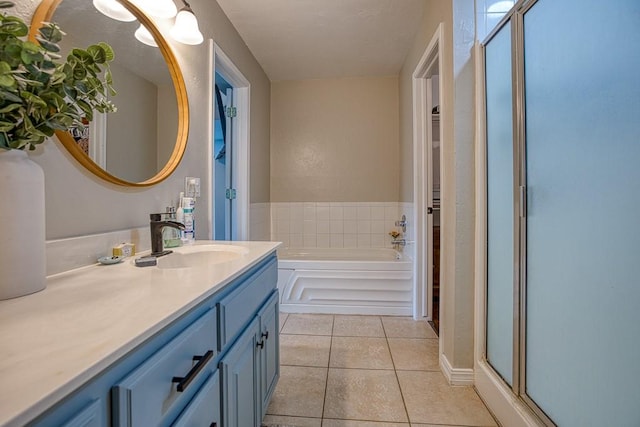 bathroom featuring tile patterned flooring, vanity, and shower with separate bathtub