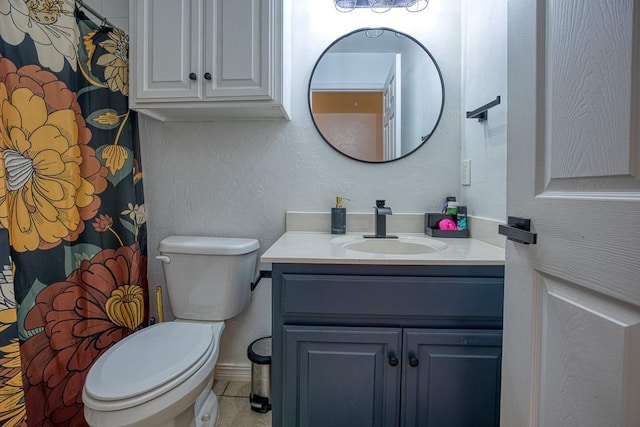 bathroom with tile patterned floors, vanity, and toilet