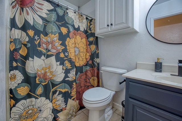 bathroom with tile patterned floors, vanity, and toilet