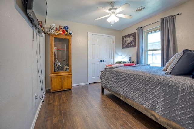 bedroom with a closet, ceiling fan, and dark wood-type flooring